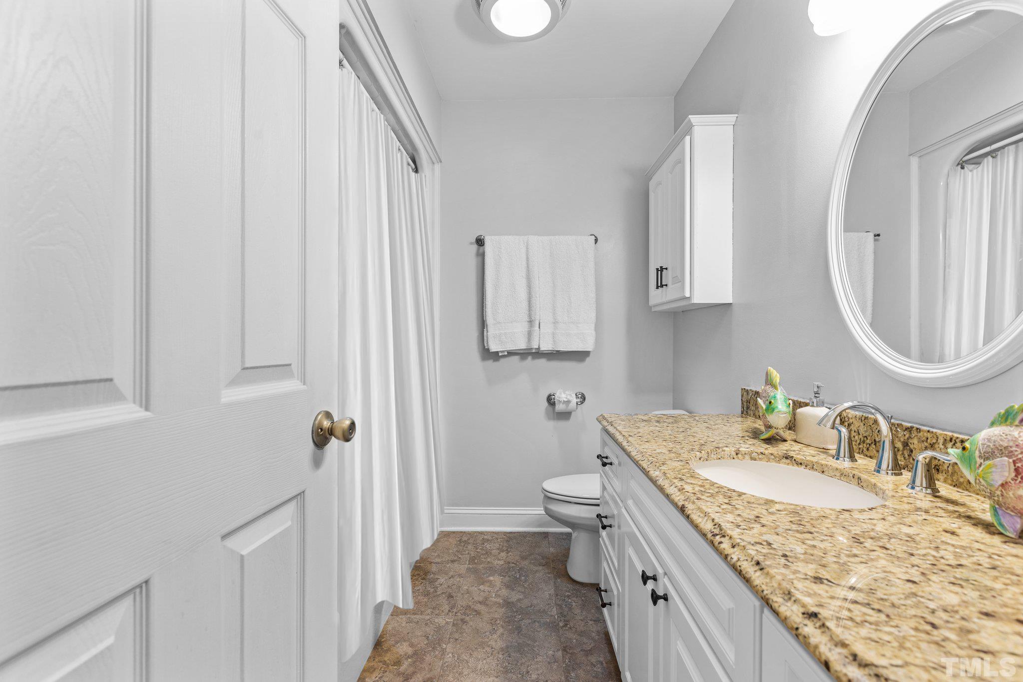 108 Rhododendron Court Chapel Hill, NC 27517 - Photo 25 of 38 a bathroom with a granite countertop sink and a mirror