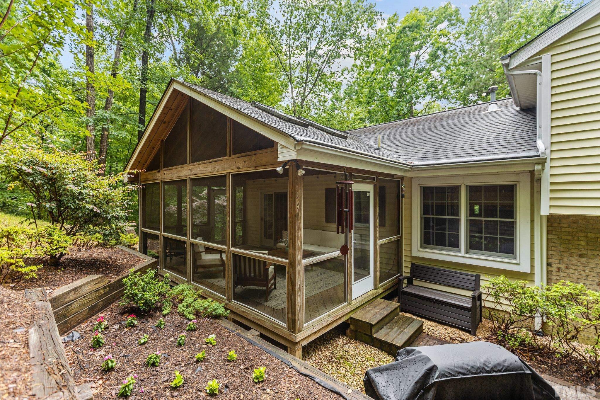 108 Rhododendron Court Chapel Hill, NC 27517 - Photo 32 of 38 a view of house with a large window and potted plants
