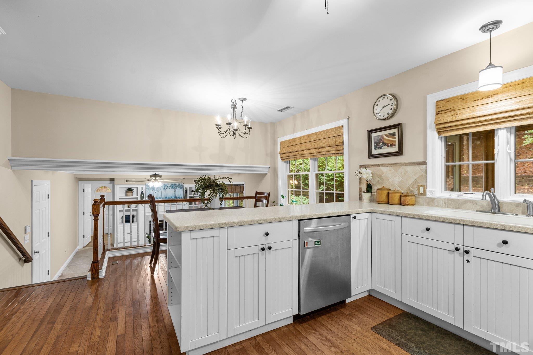 108 Rhododendron Court Chapel Hill, NC 27517 - Photo 10 of 38 a view of a kitchen with a sink wooden floor and windows