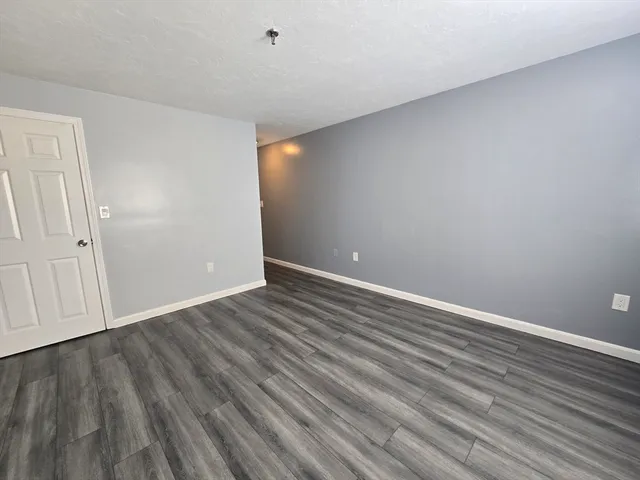 a view of hallway with wooden floor