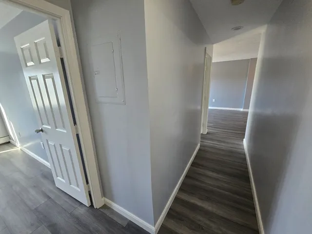 a view of a room with wooden floor