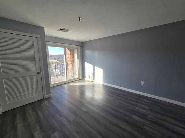 a view of an empty room and wooden floor