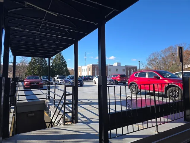 a view of a terrace with lawn chairs and a potted plant