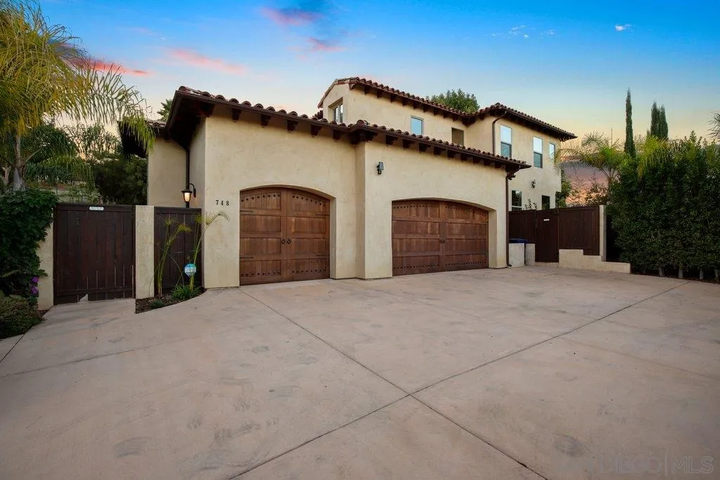 748 Rancho Santa Fe Road Encinitas, CA 92024 - Photo 4 of 59 a front view of a house with a yard and garage