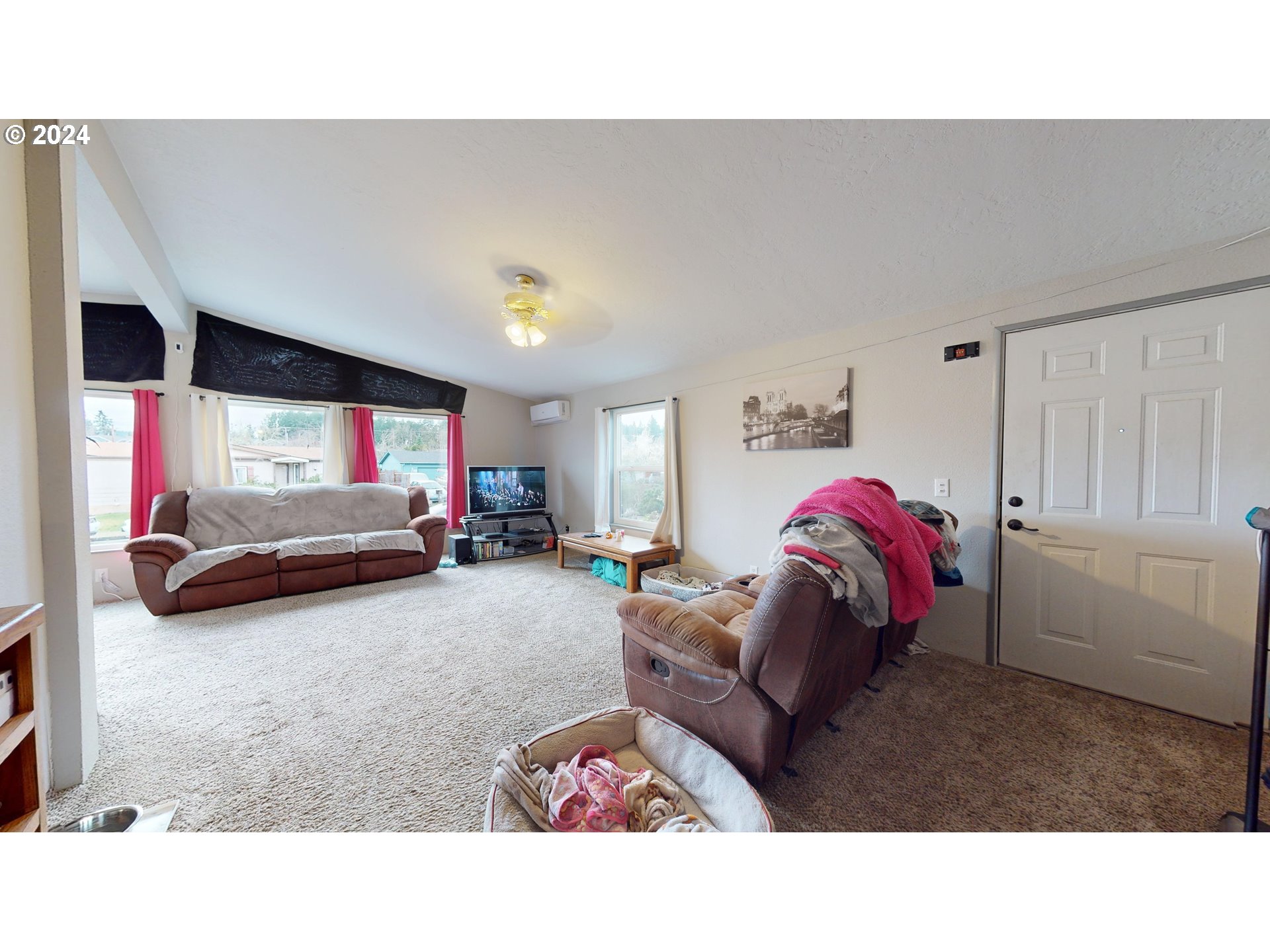 1251 South 58th Street Springfield, OR 97478 - Photo 16 of 24 a living room with furniture and a flat screen tv