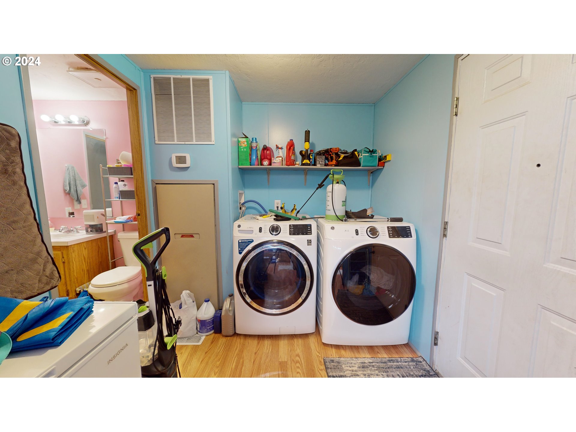 1251 South 58th Street Springfield, OR 97478 - Photo 8 of 24 a utility room with dryer washer and a view of living room