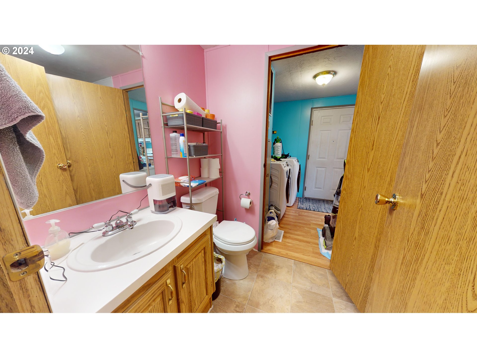 1251 South 58th Street Springfield, OR 97478 - Photo 9 of 24 a bathroom with a sink vanity mirror and toilet