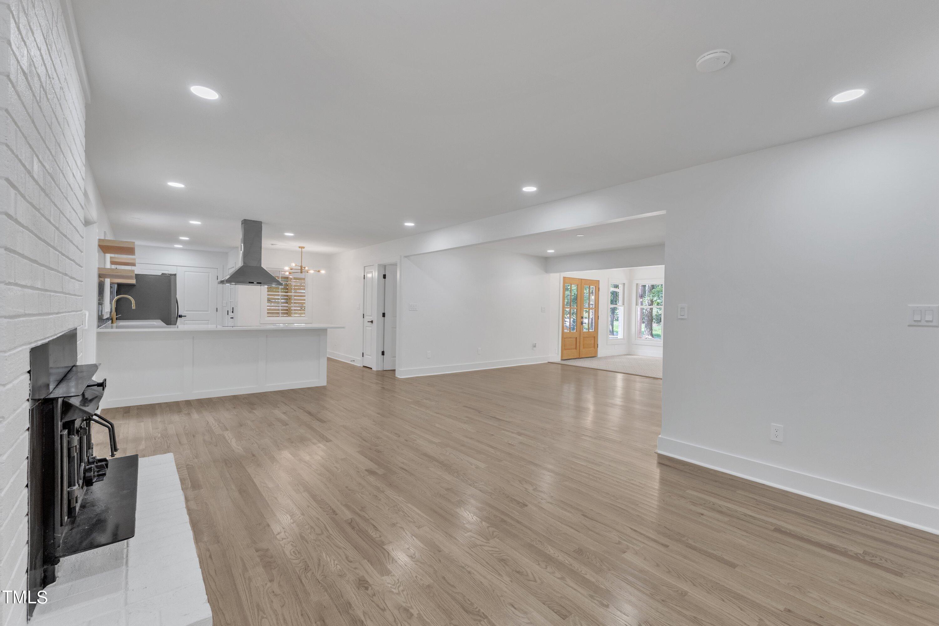 3023 Creech Road Garner, NC 27529 - Photo 12 of 42 a view of kitchen and hall with wooden floor