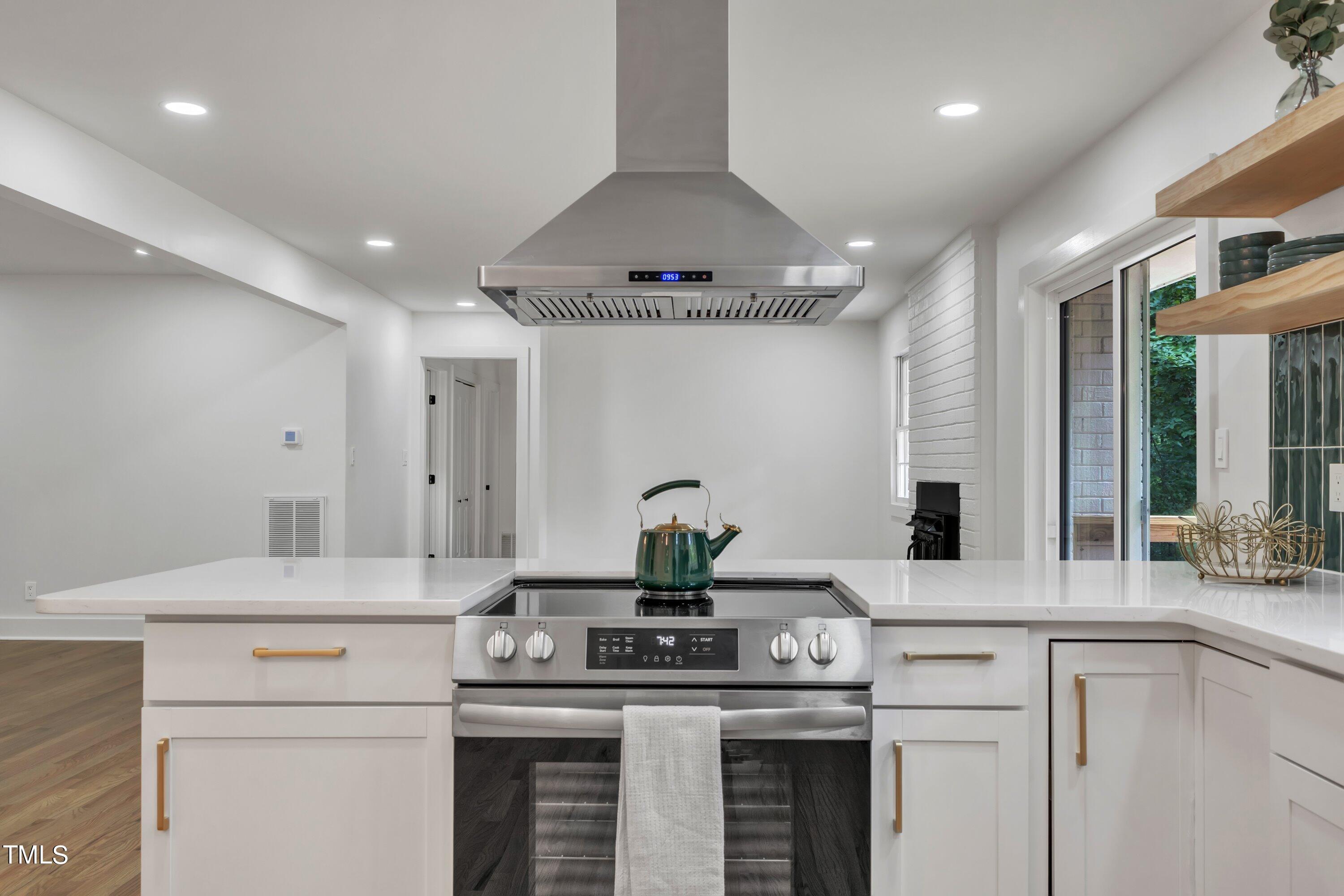 3023 Creech Road Garner, NC 27529 - Photo 15 of 42 a kitchen with a sink stainless steel appliances and cabinets