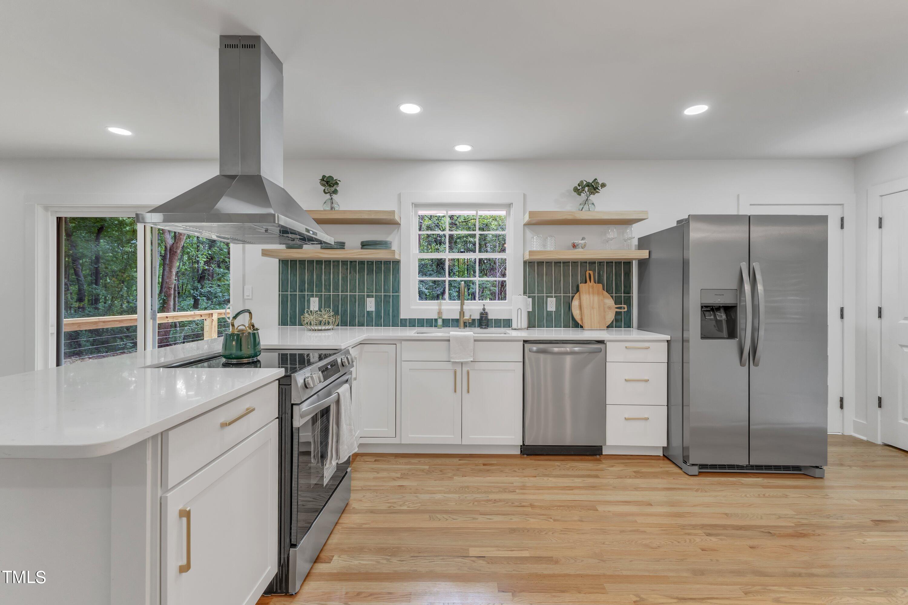 3023 Creech Road Garner, NC 27529 - Photo 18 of 42 a kitchen with a stove a refrigerator and a sink