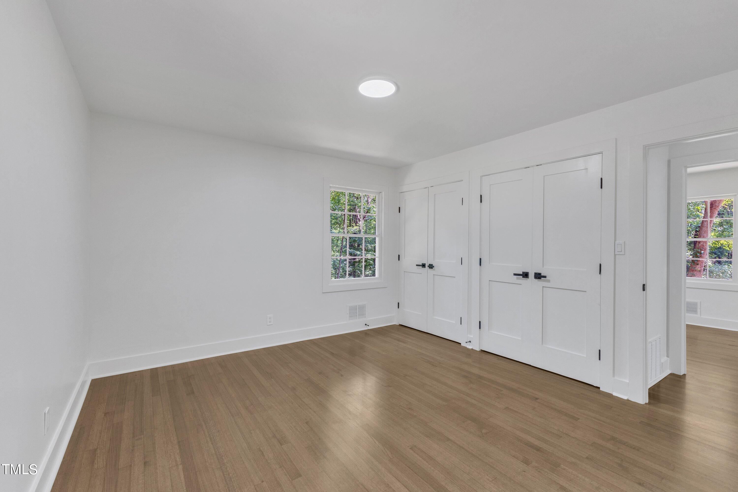 3023 Creech Road Garner, NC 27529 - Photo 21 of 42 a view of an empty room with wooden floor and a window