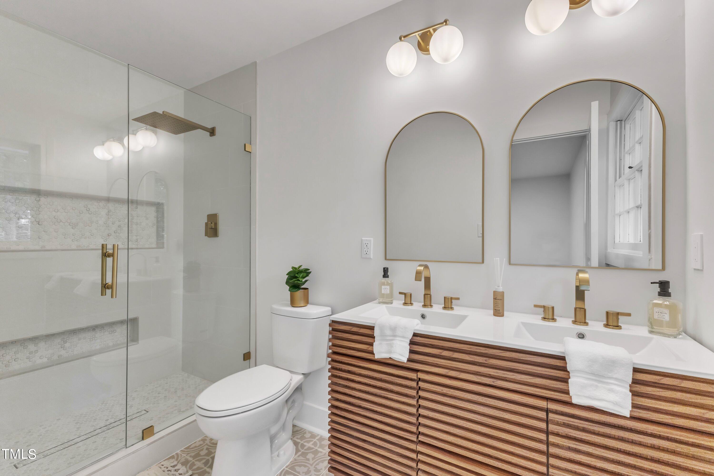 3023 Creech Road Garner, NC 27529 - Photo 23 of 42 a bathroom with a sink and a mirror