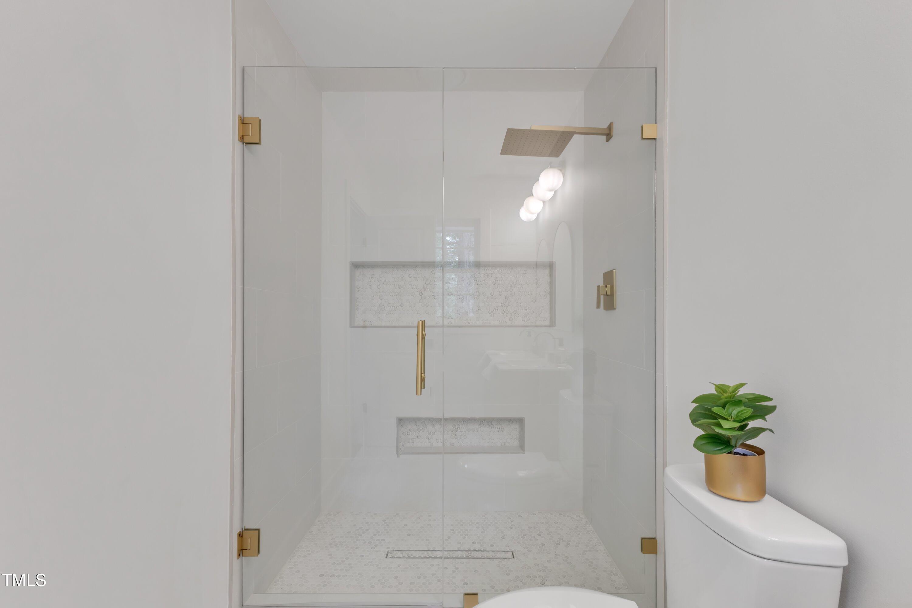 3023 Creech Road Garner, NC 27529 - Photo 24 of 42 a bathroom with a shower and toilet