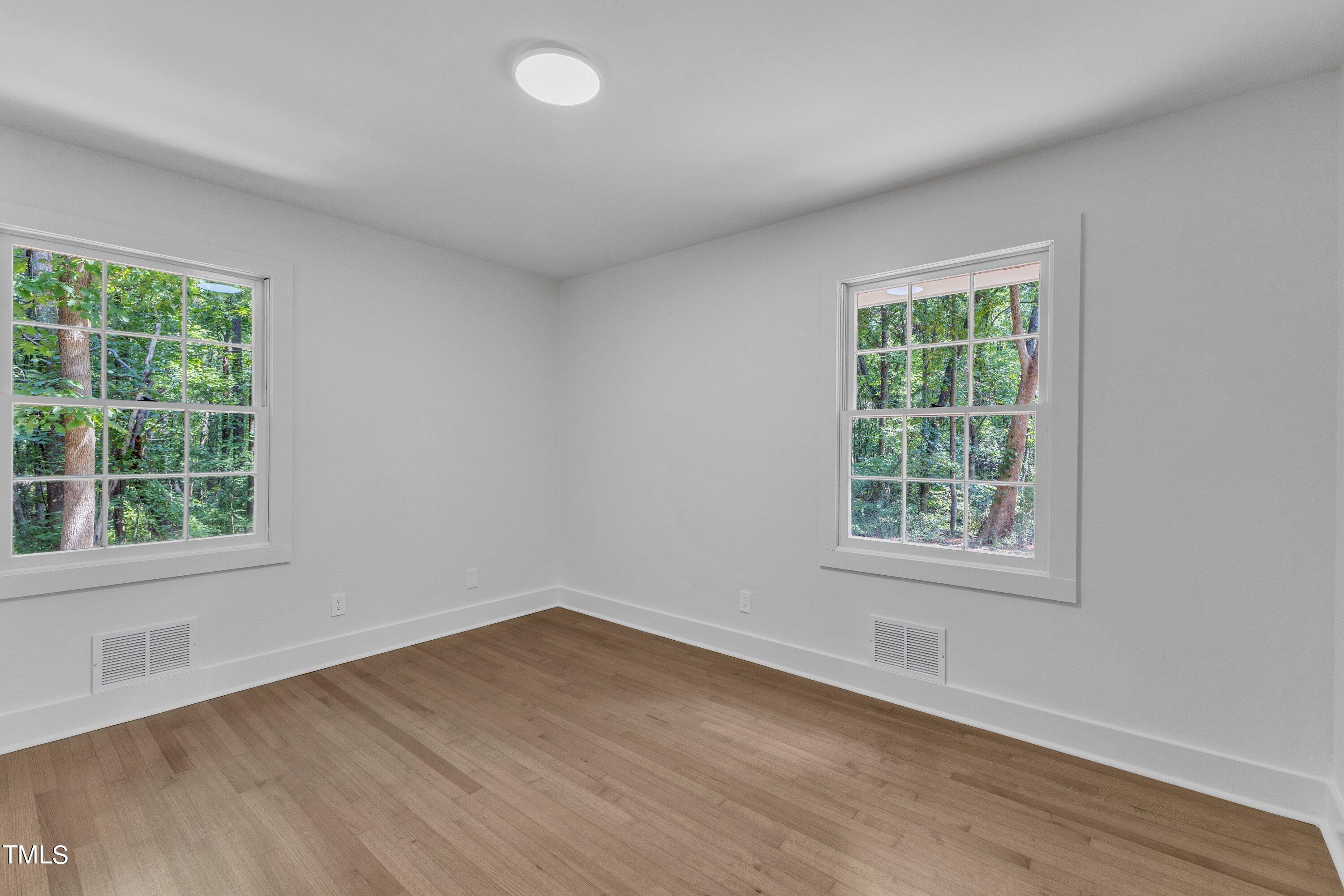 3023 Creech Road Garner, NC 27529 - Photo 27 of 42 an empty room with wooden floor and windows