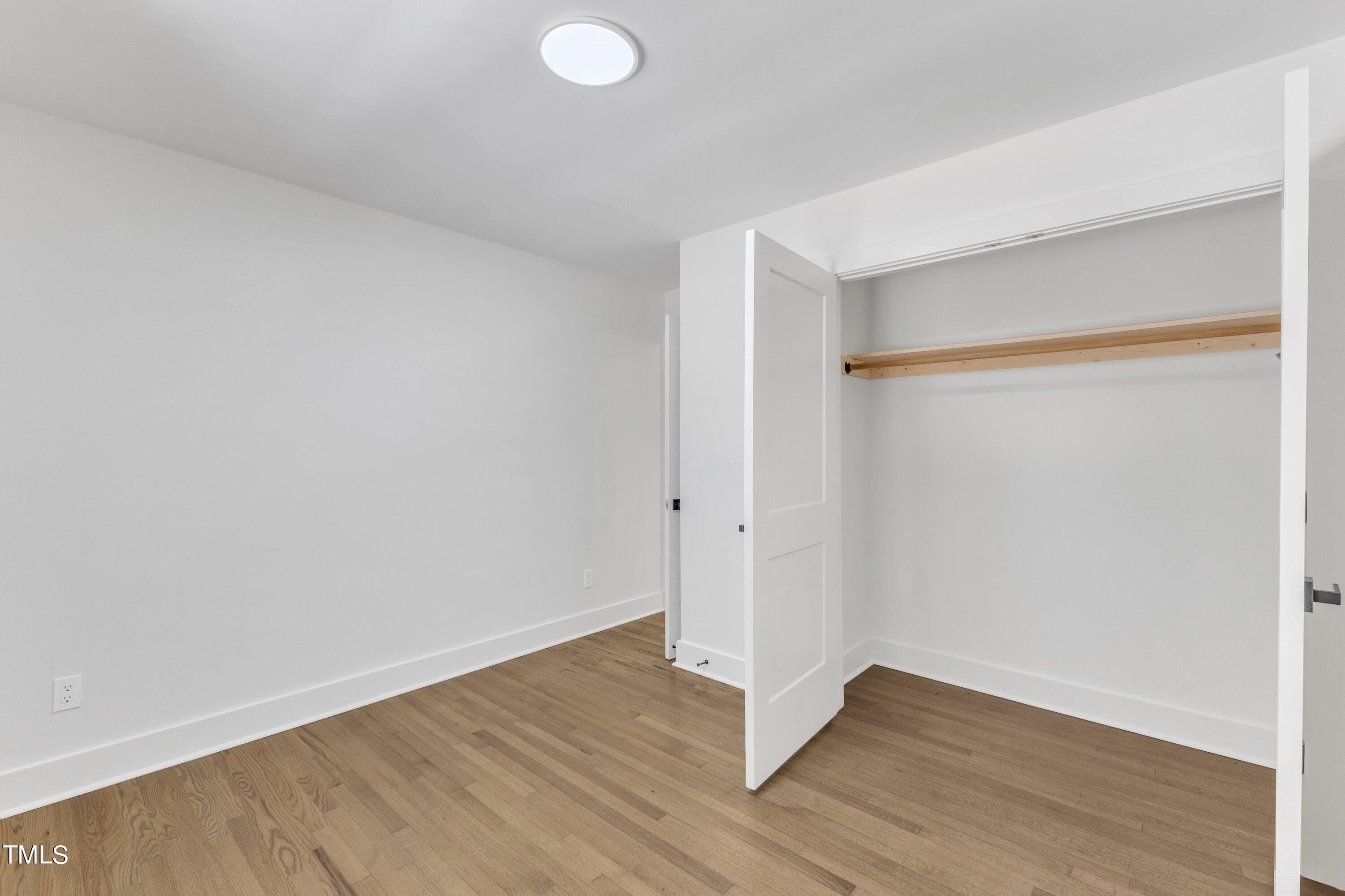 3023 Creech Road Garner, NC 27529 - Photo 30 of 42 a view of an empty room with wooden floor