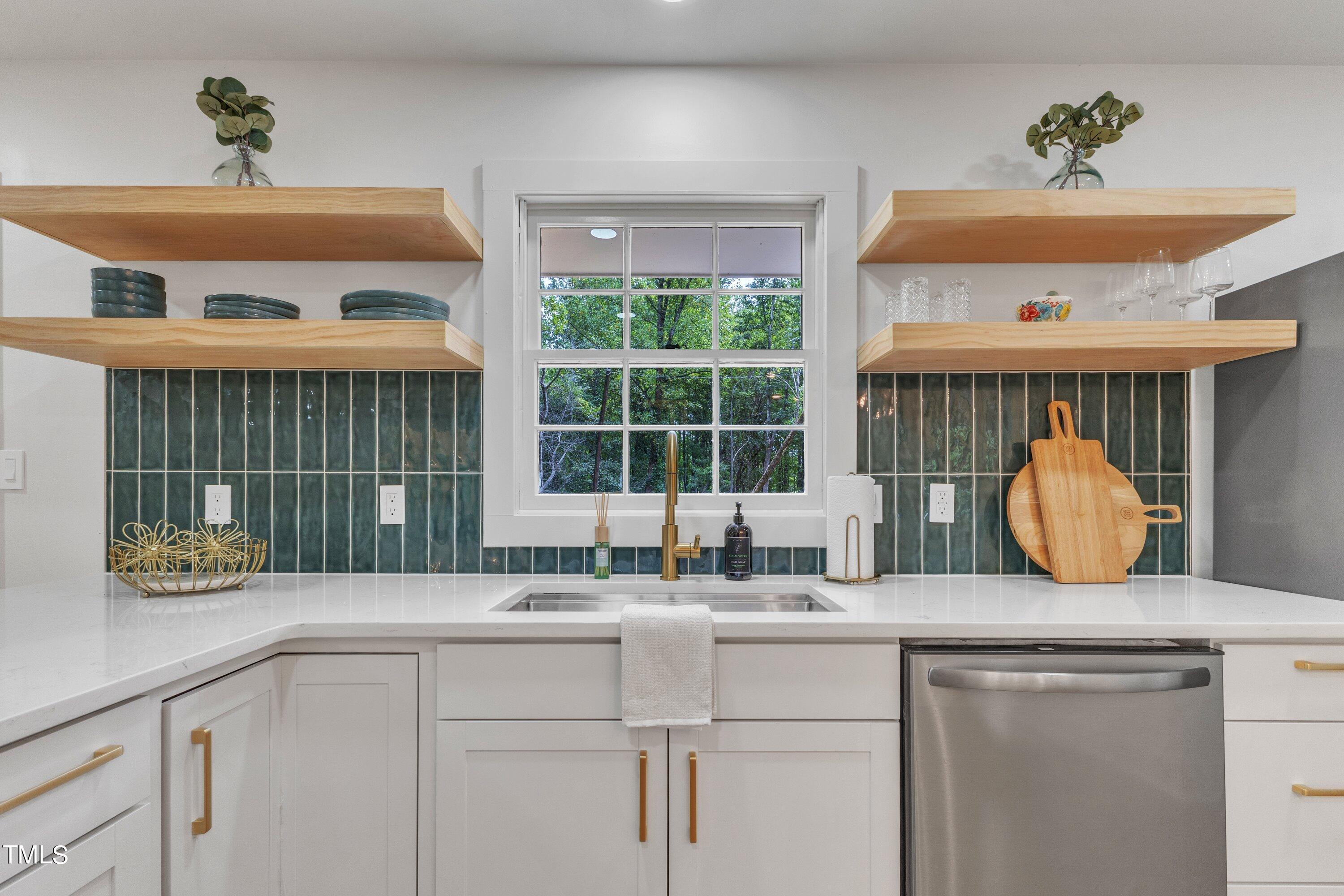 3023 Creech Road Garner, NC 27529 - Photo 3 of 42 a kitchen with a sink and a window