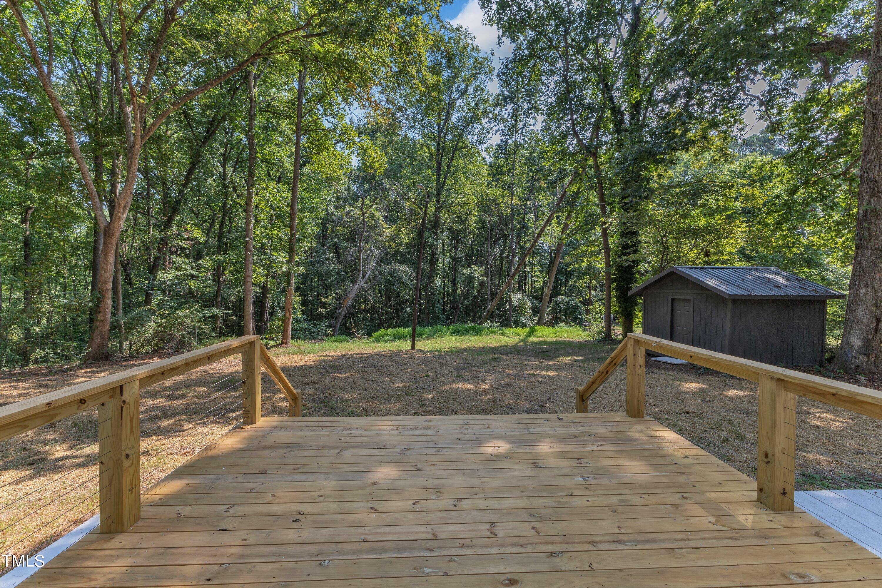 3023 Creech Road Garner, NC 27529 - Photo 32 of 42 a backyard of a house with lots of green space