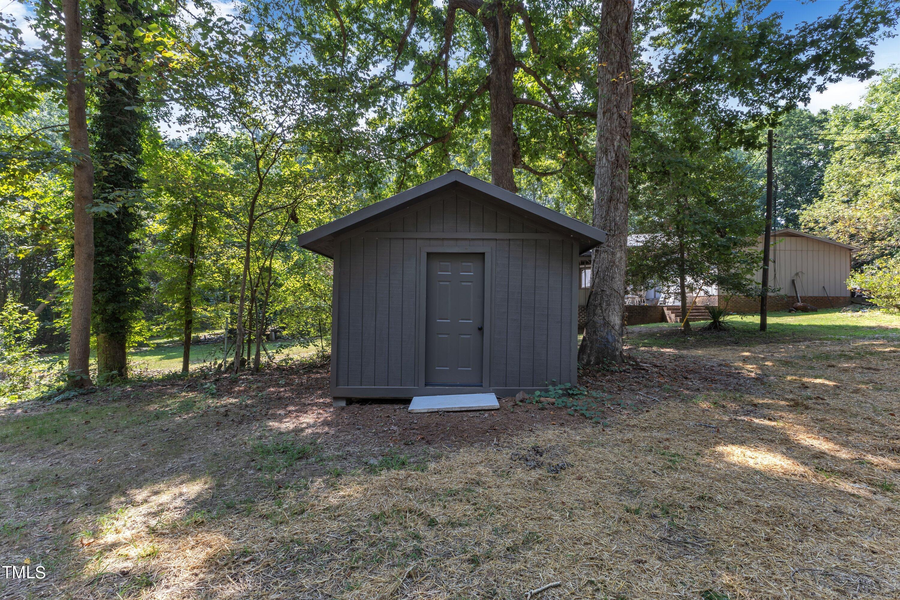 3023 Creech Road Garner, NC 27529 - Photo 37 of 42 a wooden house with a yard and large trees