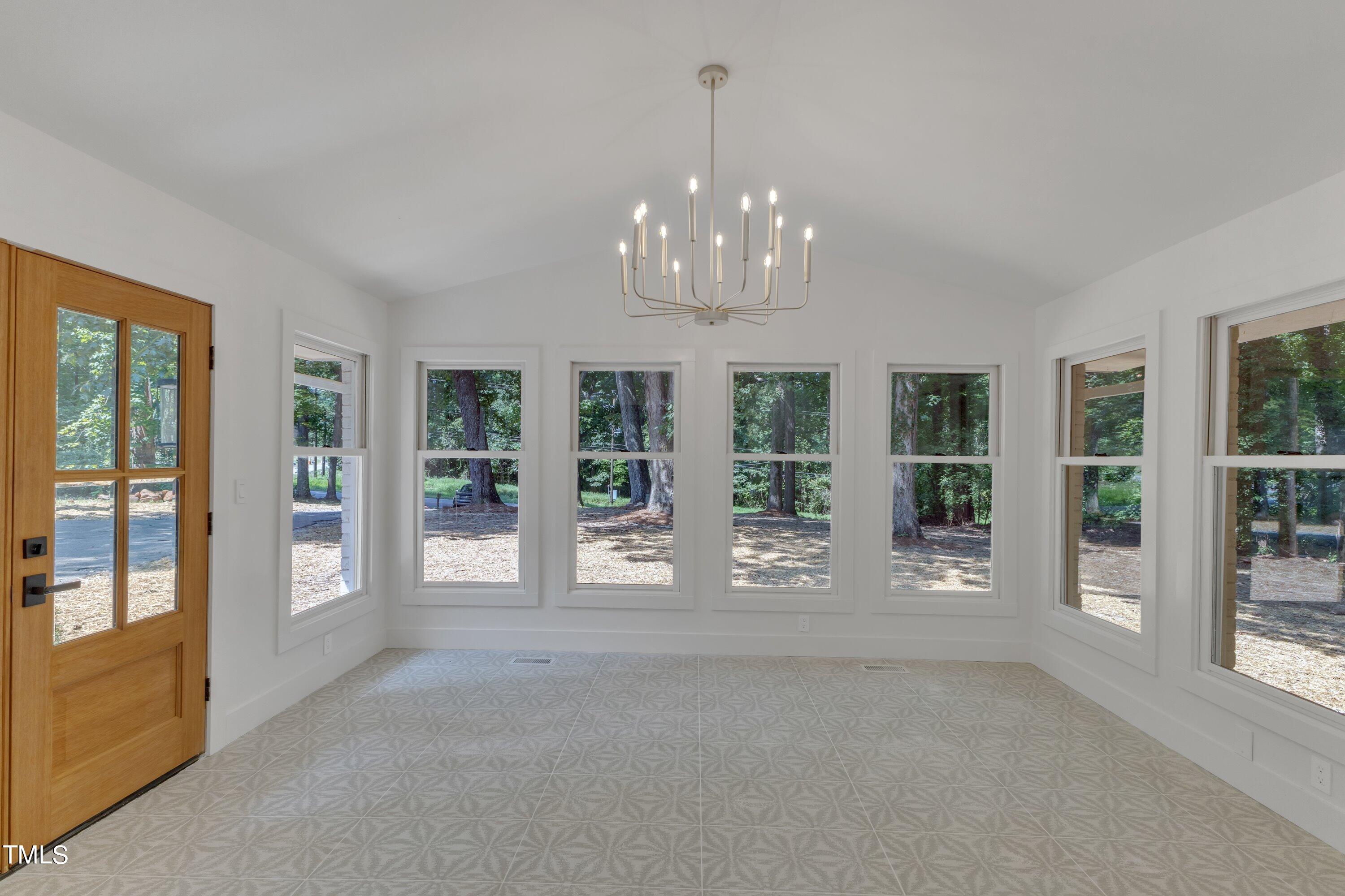 3023 Creech Road Garner, NC 27529 - Photo 6 of 42 a view of an empty room with windows and entryway