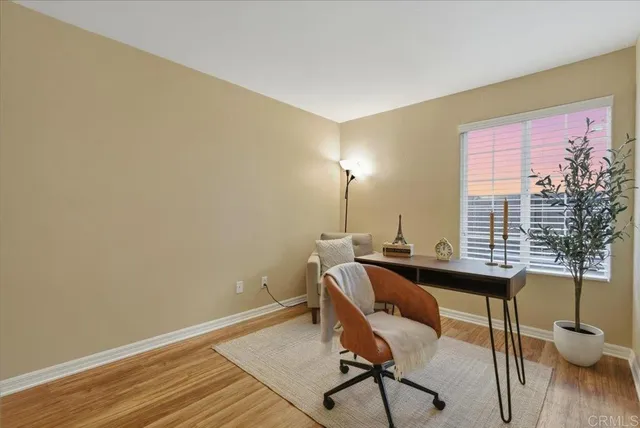 a view of a workspace with furniture and a window