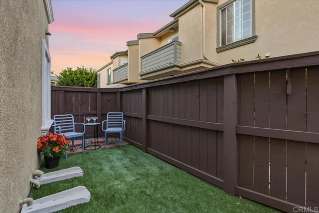 a view of backyard with deck and outdoor seating