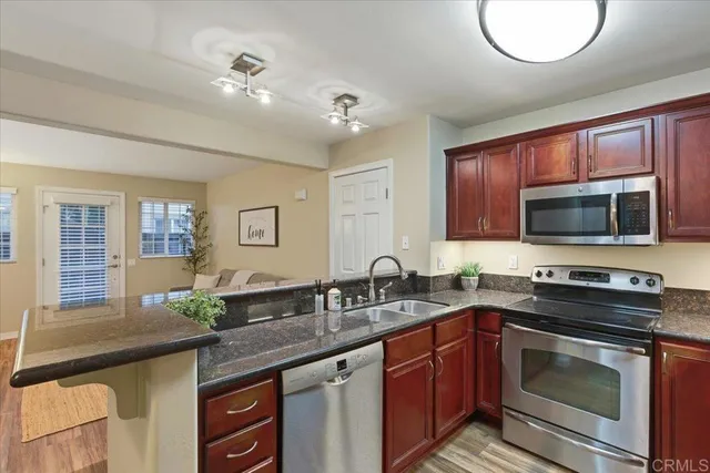 a kitchen with a sink stove and microwave