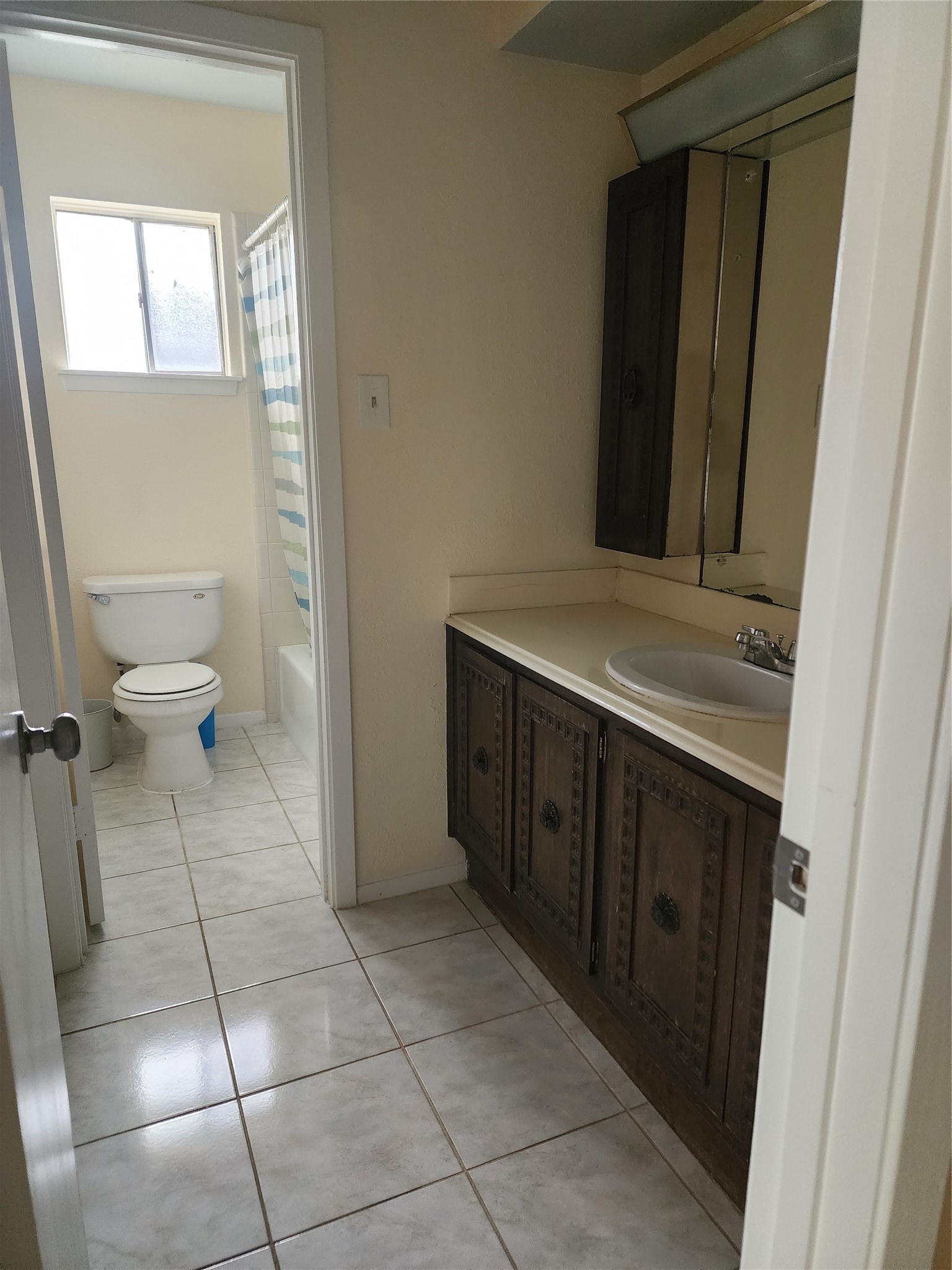 9110 Grape Street Houston, TX 77036 - Photo 15 of 17 a bathroom with a sink vanity and a toilet
