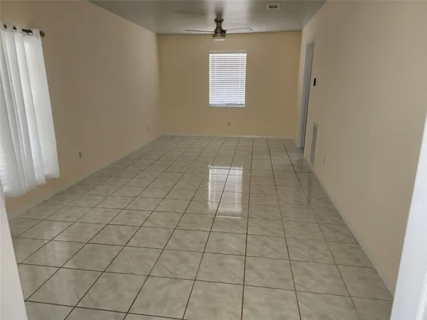 an empty room with white walls and tiles