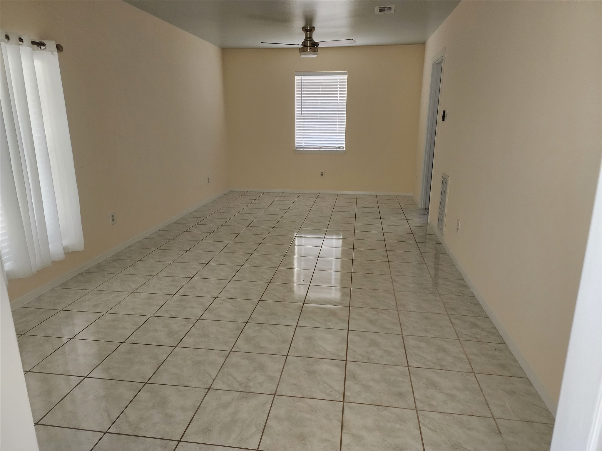 9110 Grape Street Houston, TX 77036 - Photo 2 of 17 an empty room with white walls and tiles