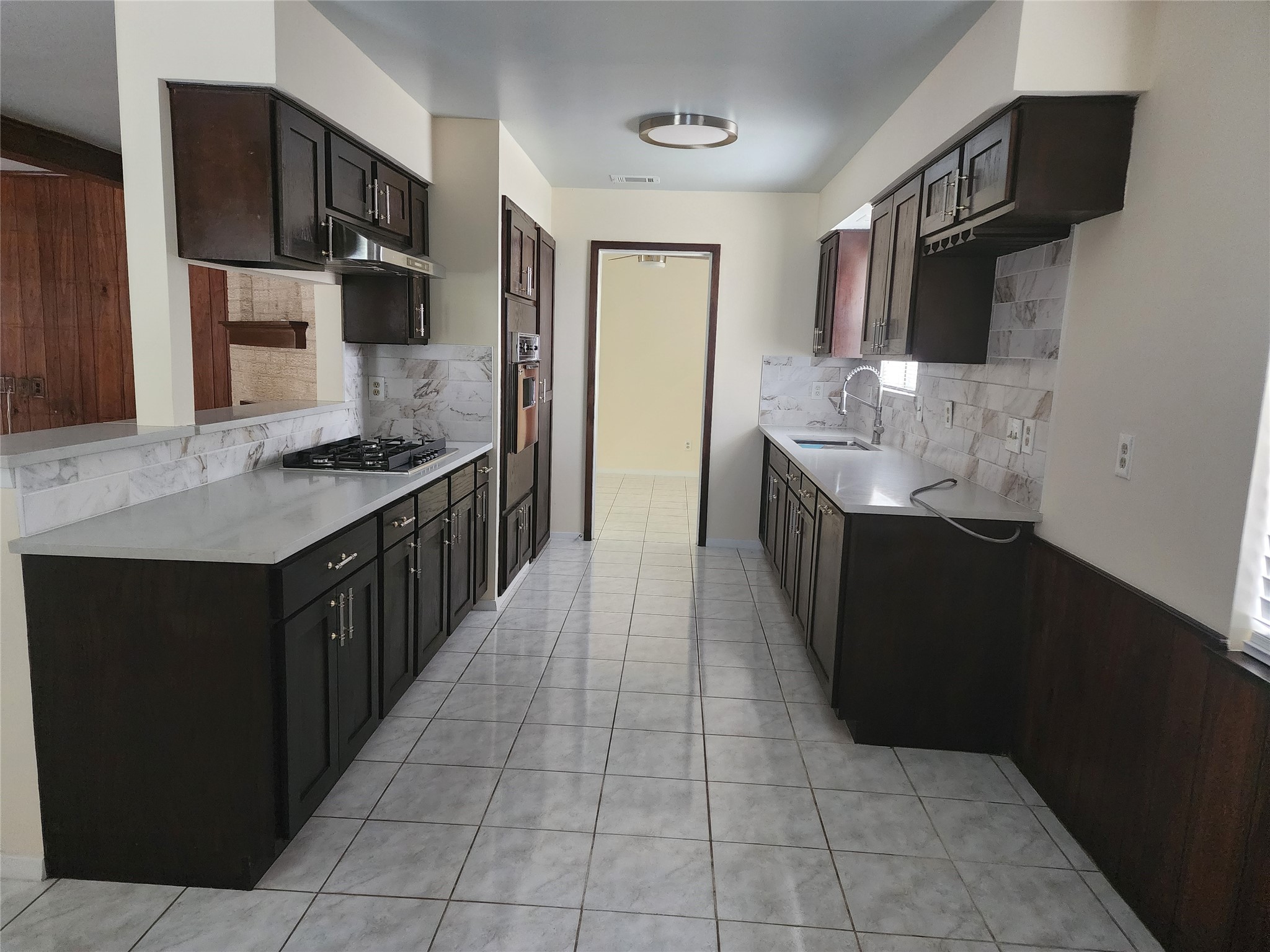 9110 Grape Street Houston, TX 77036 - Photo 3 of 17 a kitchen with stainless steel appliances granite countertop a sink stove and refrigerator