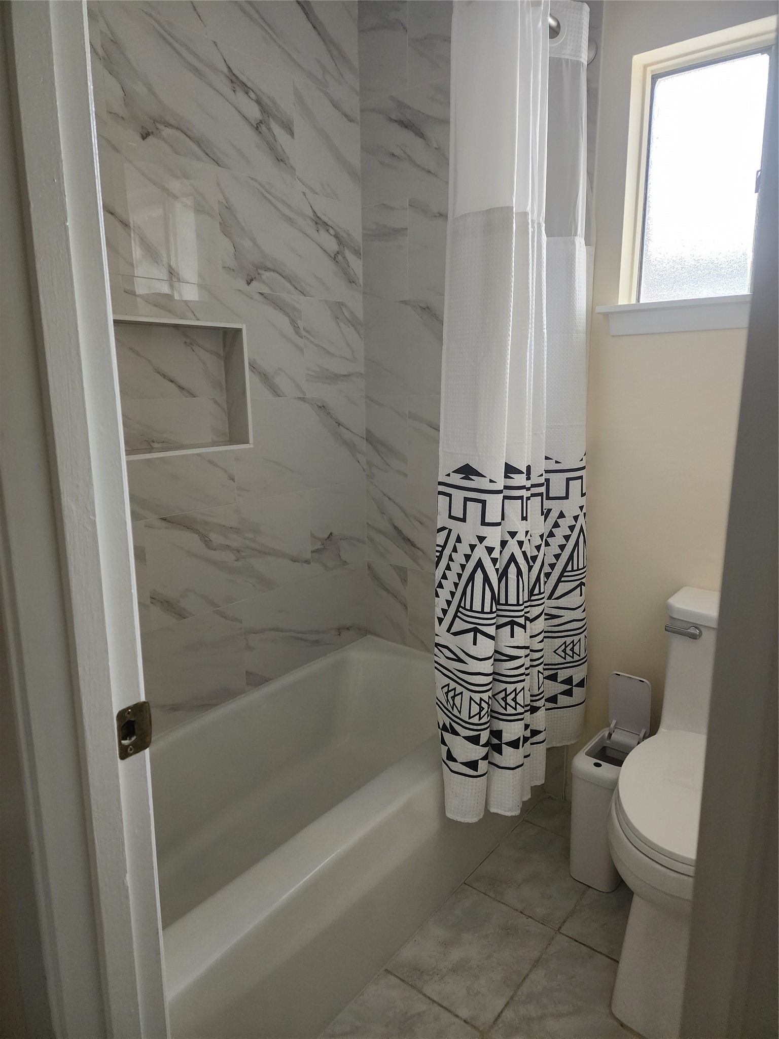 9110 Grape Street Houston, TX 77036 - Photo 10 of 17 a bathroom with a toilet and a shower