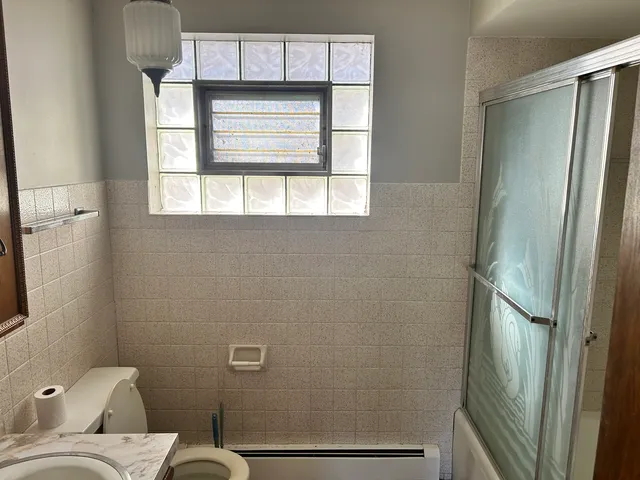 a bathroom with a toilet sink and tub