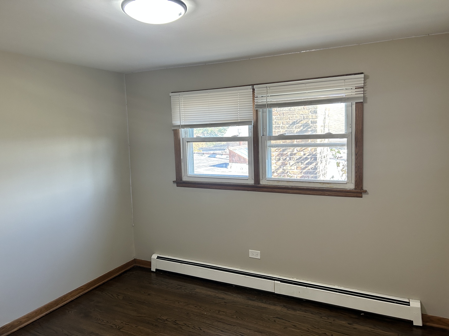 5645 West 63rd Place, Unit 2 Chicago, IL 60638 - Photo 5 of 13 a view of a room with wooden floor and windows