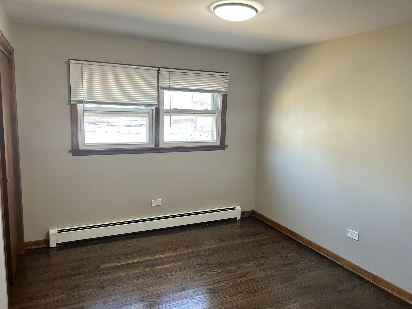 5645 West 63rd Place, Unit 2 Chicago, IL 60638 - Photo 7 of 13 an empty room with wooden floor and windows