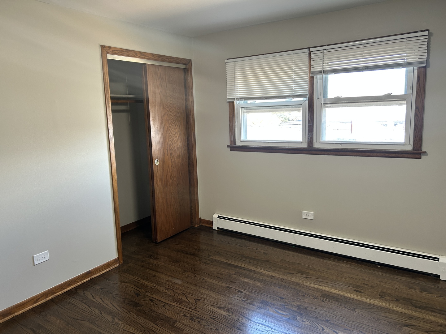 5645 West 63rd Place, Unit 2 Chicago, IL 60638 - Photo 8 of 13 an empty room with wooden floor and windows