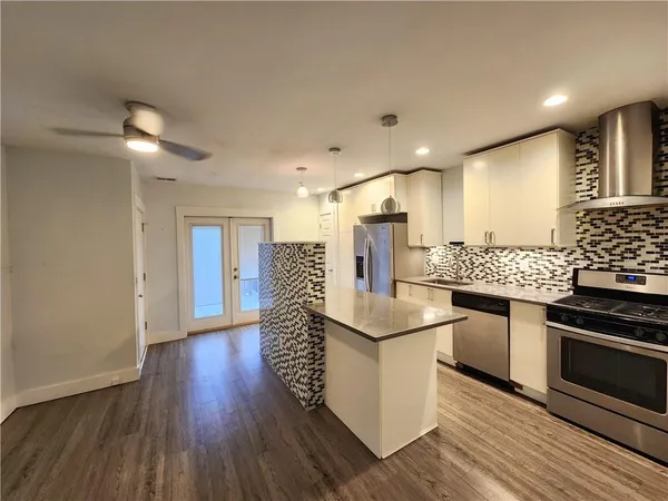 a kitchen with stainless steel appliances granite countertop a stove and a refrigerator