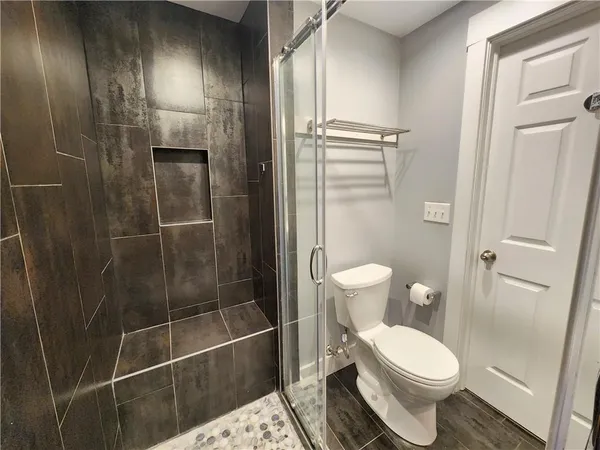 a bathroom with a toilet and a shower
