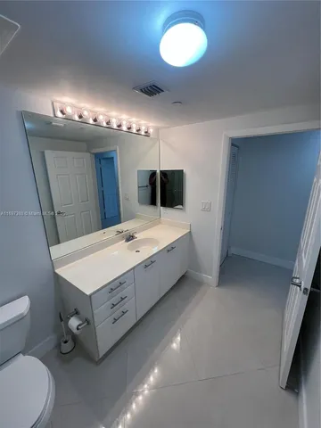 a view of a hallway with a book and a bed