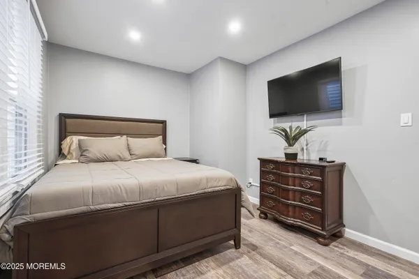 a bedroom with a bed and a flat screen tv