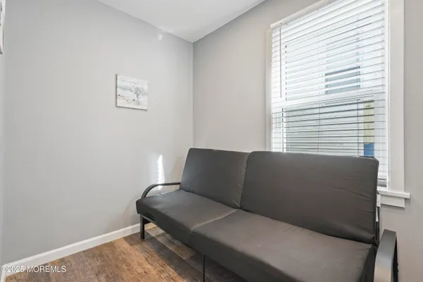 a couch sitting in a bedroom next to a window