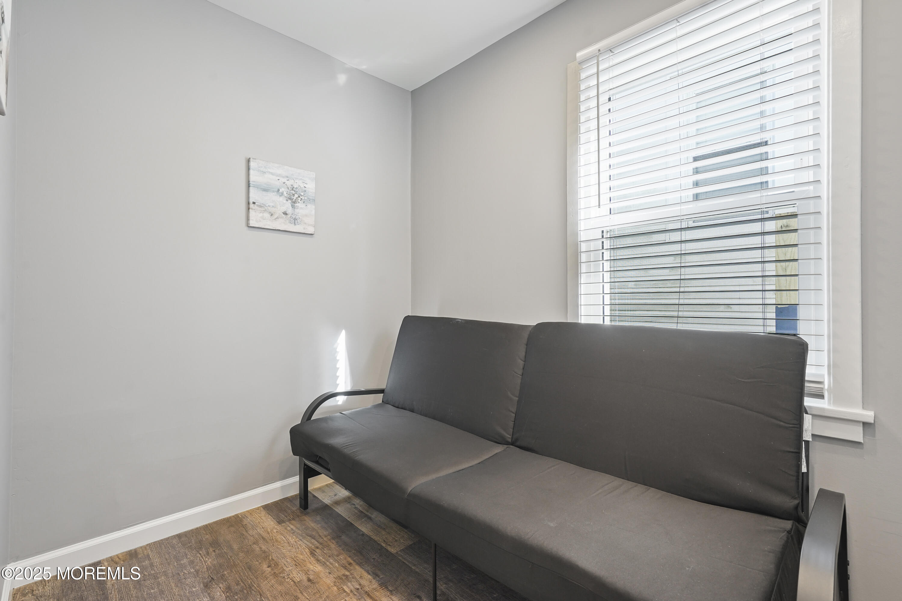 214 Webster Avenue, Unit 1 Seaside Heights, NJ 08751 - Photo 16 of 24 a couch sitting in a bedroom next to a window