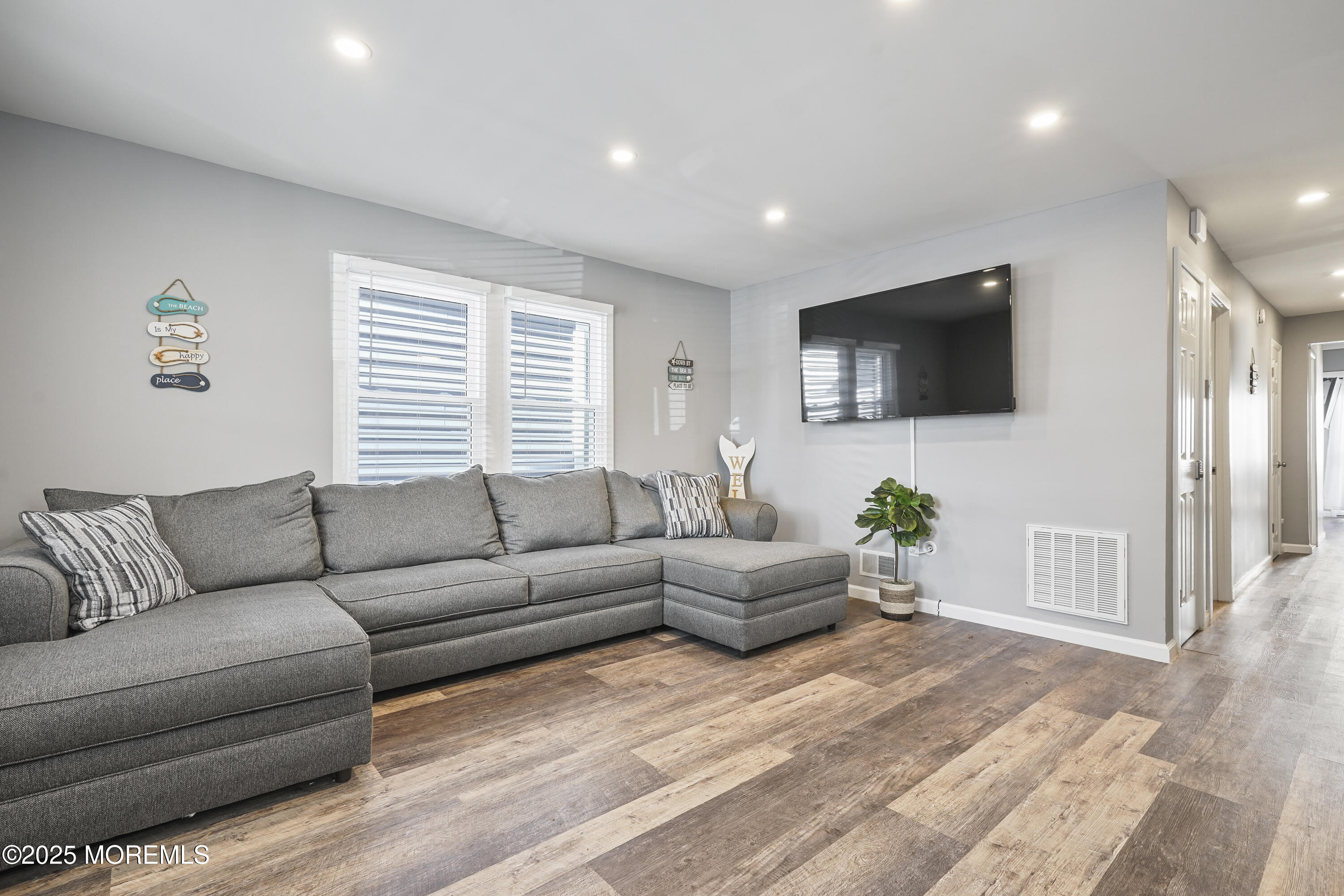214 Webster Avenue, Unit 1 Seaside Heights, NJ 08751 - Photo 21 of 24 a living room with furniture and a flat screen tv