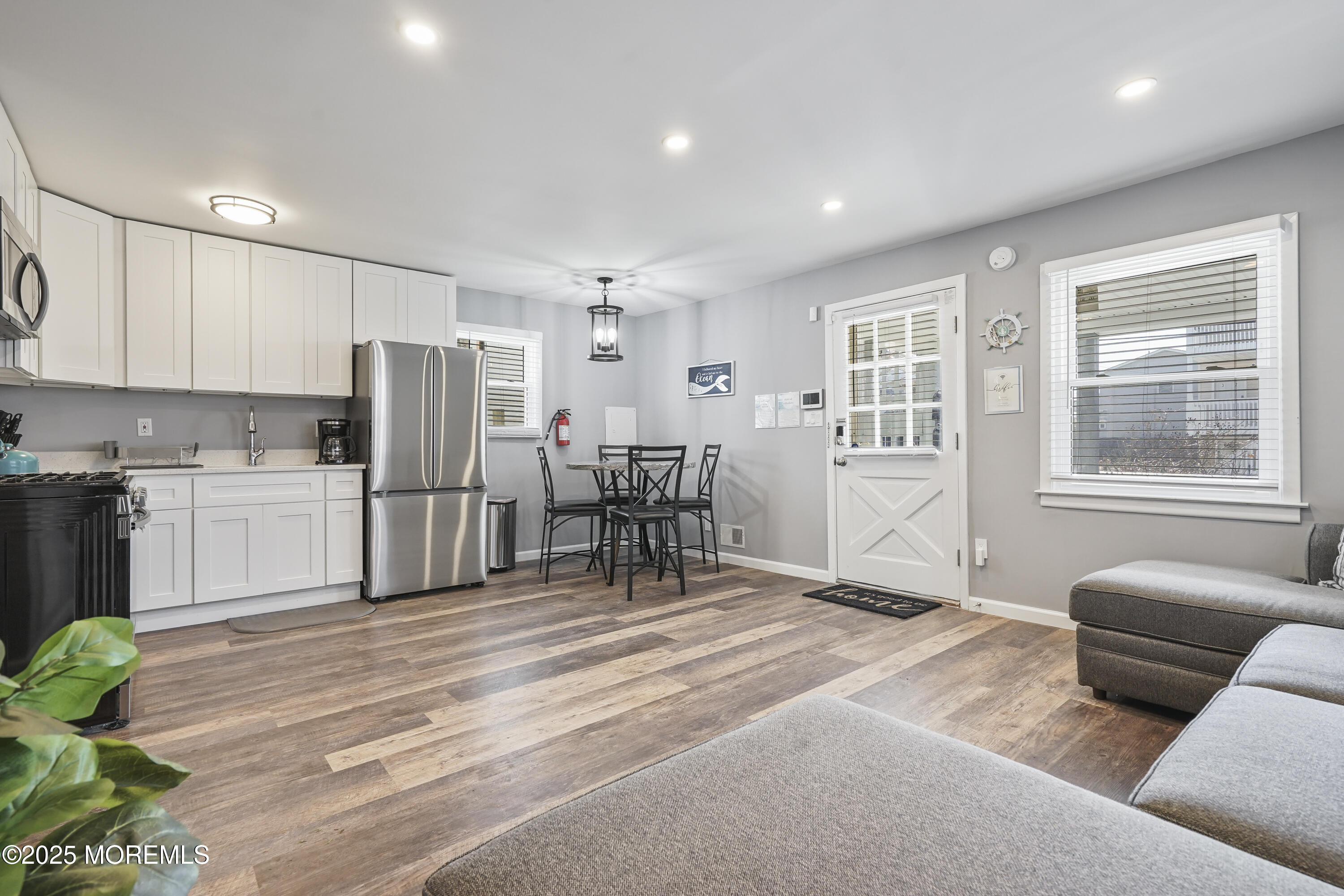 214 Webster Avenue, Unit 1 Seaside Heights, NJ 08751 - Photo 6 of 24 a living room with furniture and a refrigerator