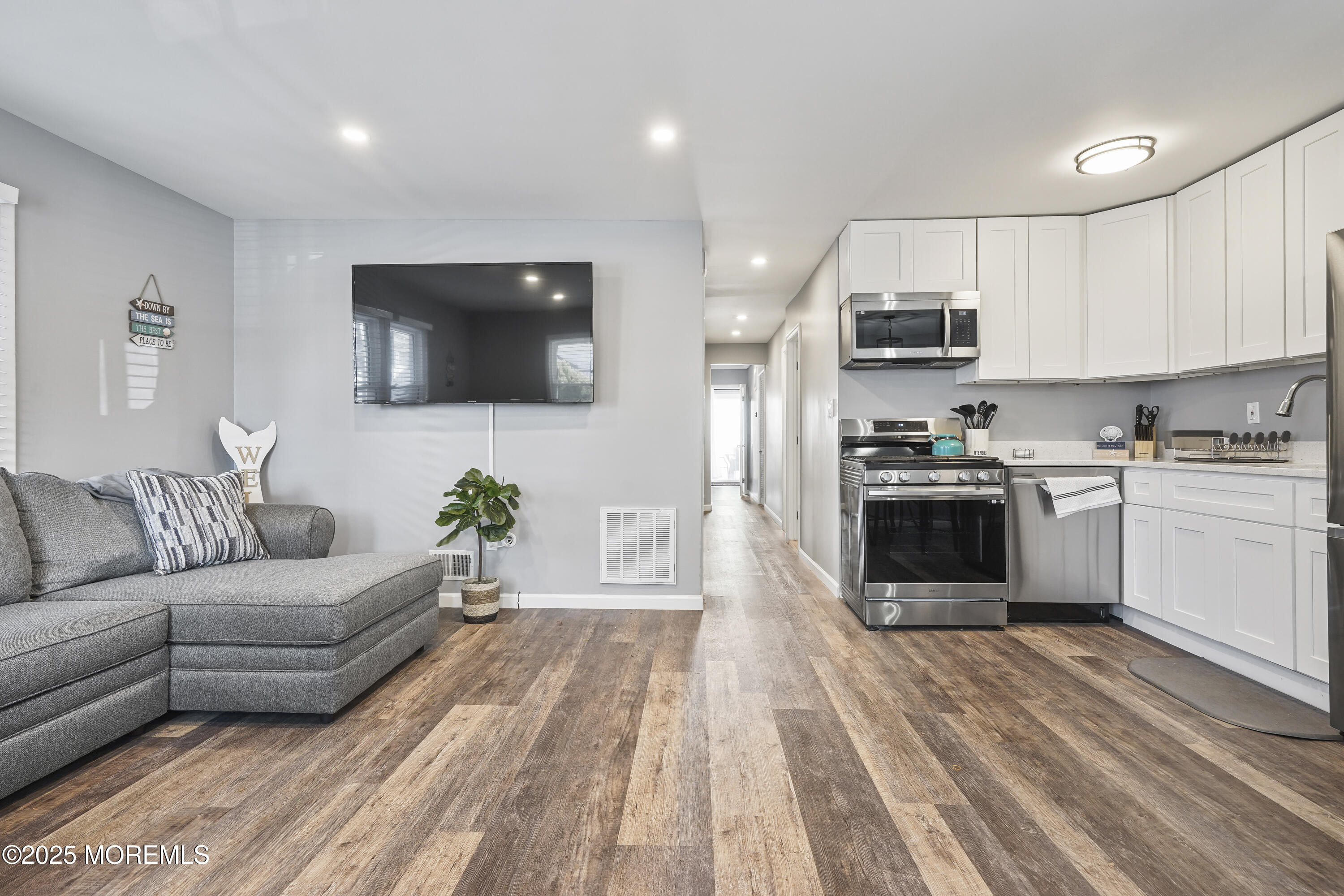 214 Webster Avenue, Unit 1 Seaside Heights, NJ 08751 - Photo 7 of 24 a living room with stainless steel appliances furniture cabinets and a wooden floor