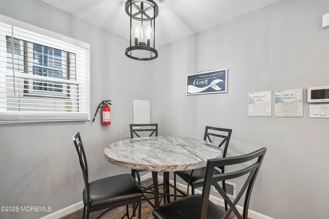 a view of a dining room with furniture and a window