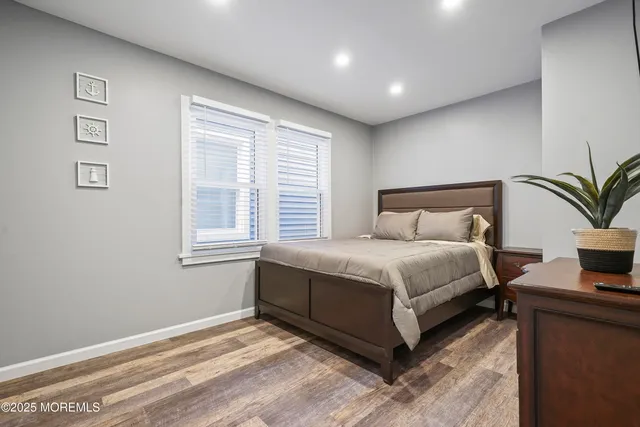 a bedroom with a large bed and a potted plant