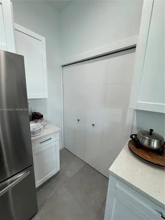 a kitchen with a refrigerator and a stove