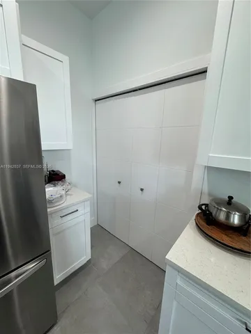 a kitchen with a refrigerator and a stove
