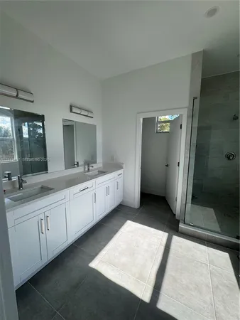 a bathroom with a double vanity sink and mirror