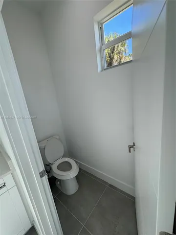 a white toilet sitting next to a sink